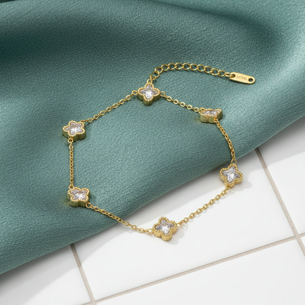 A gold chain bracelet featuring five star-shaped charms, each adorned with a clear rhinestone. The anklet is displayed on a clean white background, with its extender chain and clasp visible.